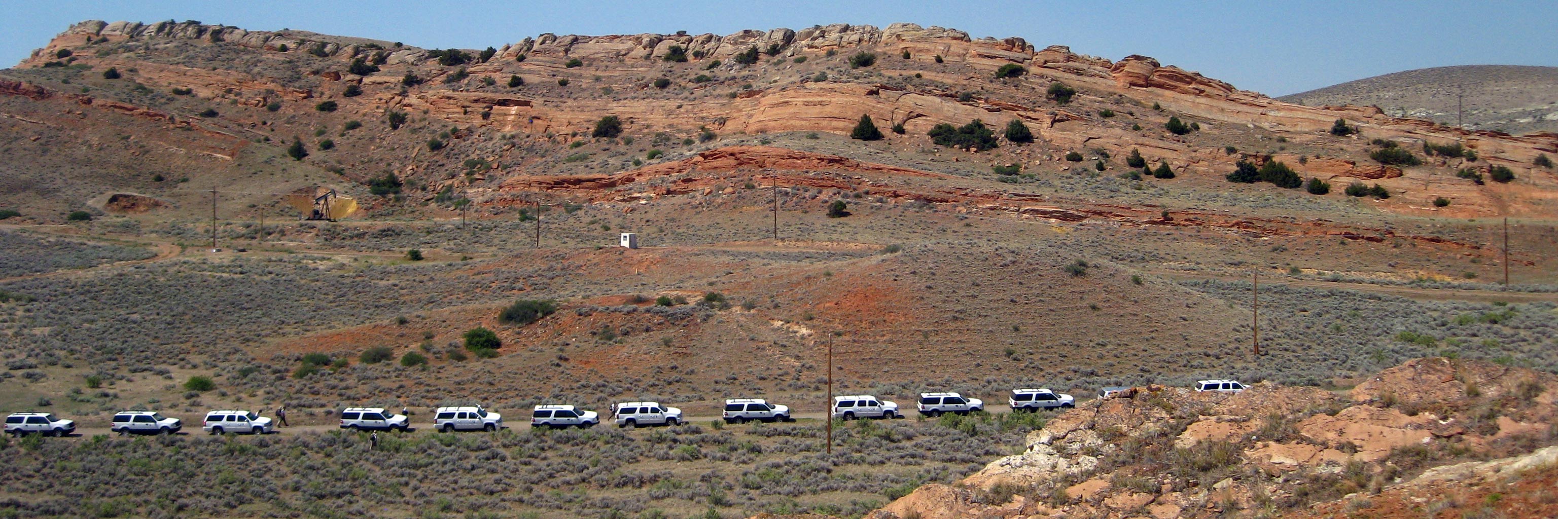 line of trucks on desert road