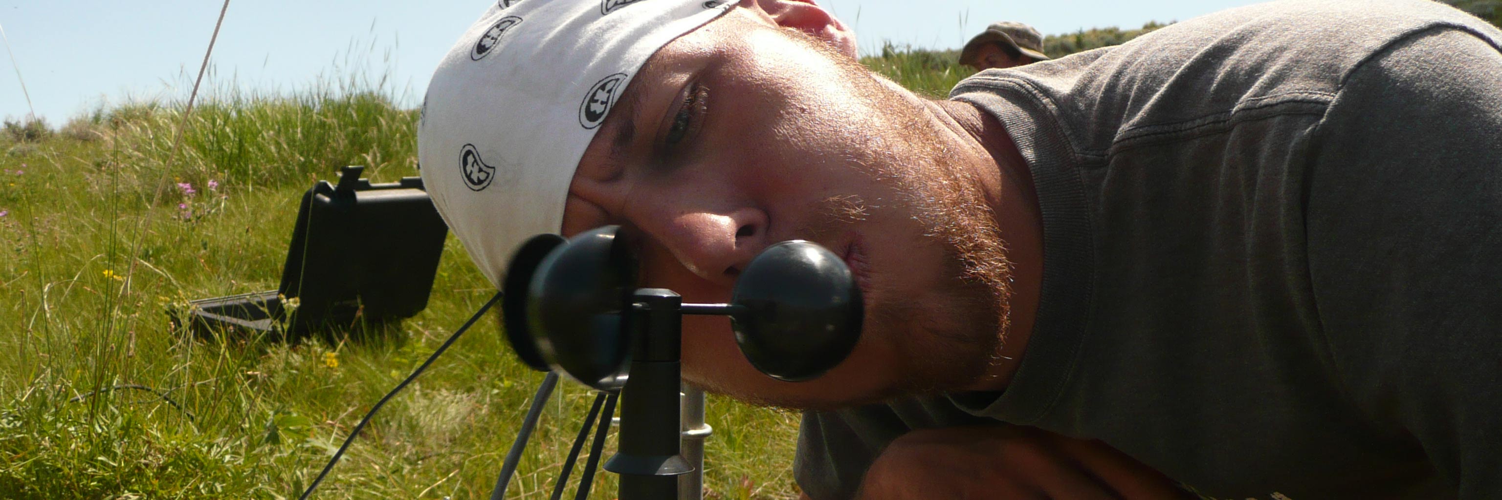 student looking into a wind meter