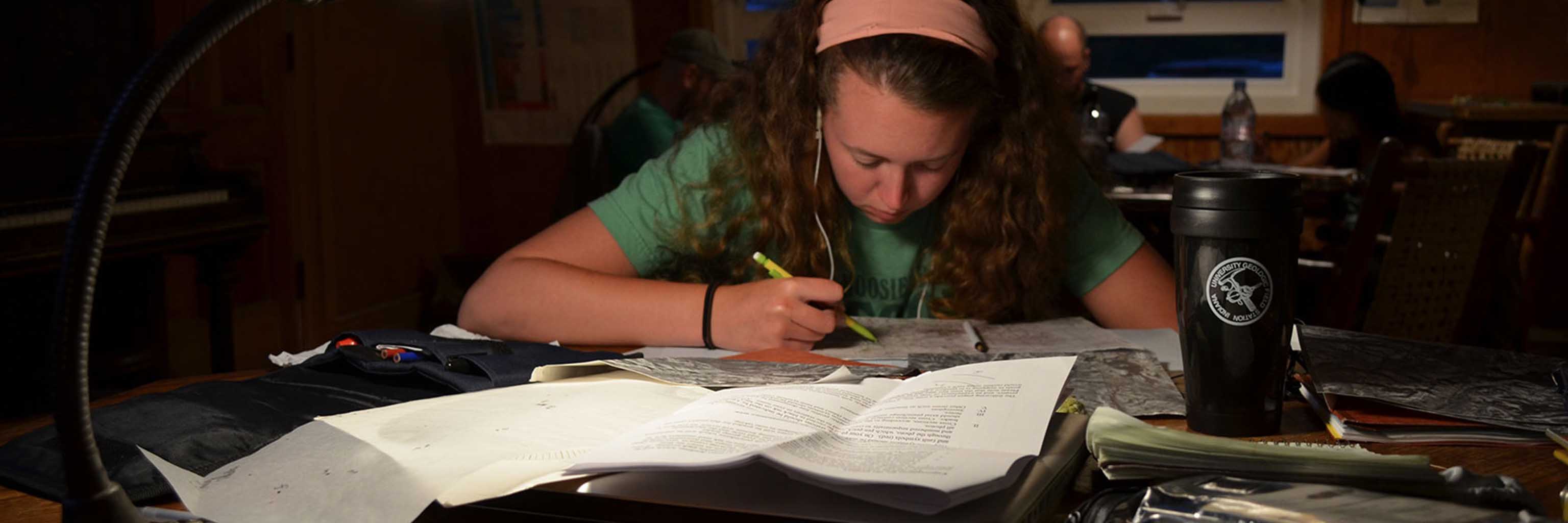 female student with headphones studying