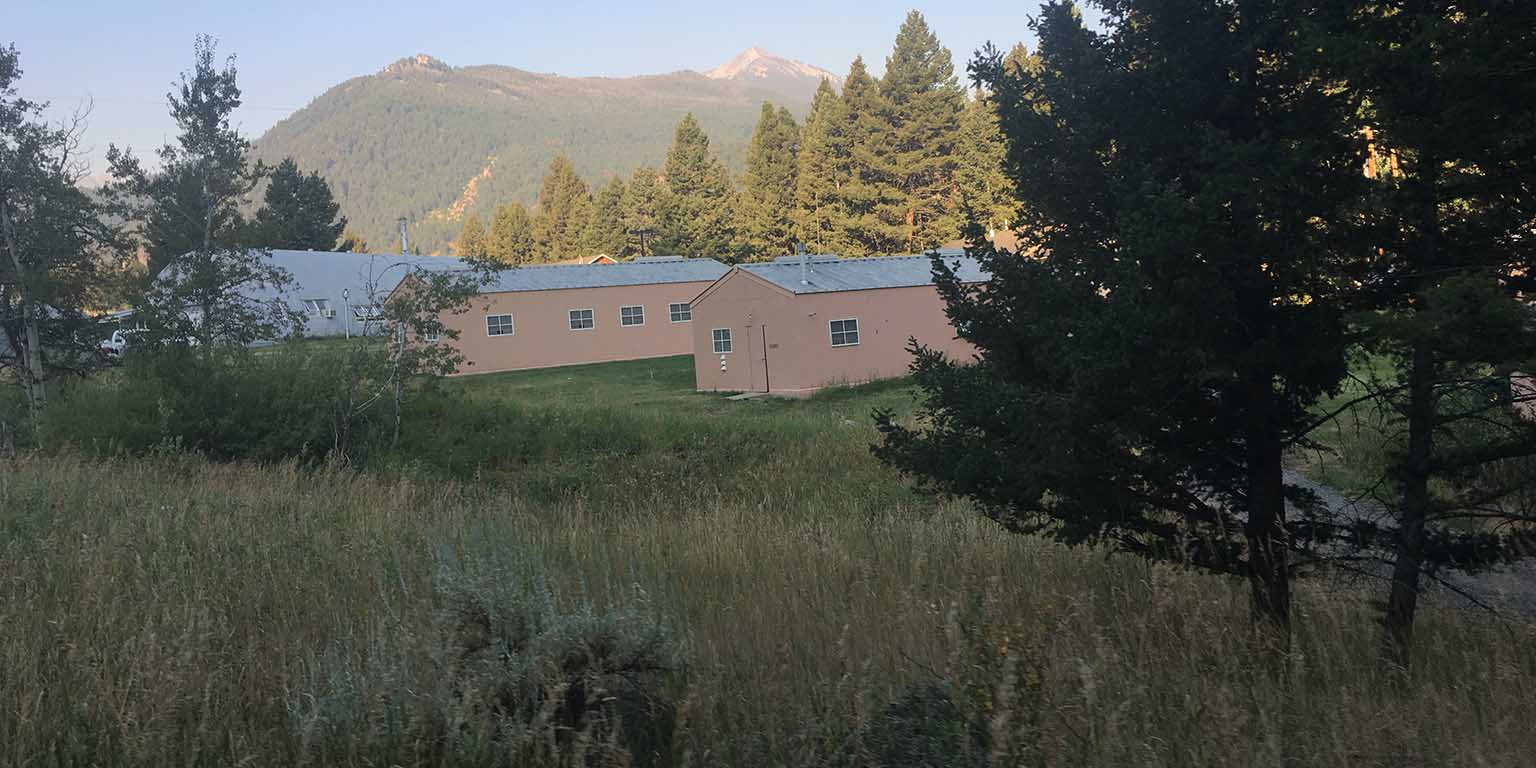 overview photo of housing with mountains in the background